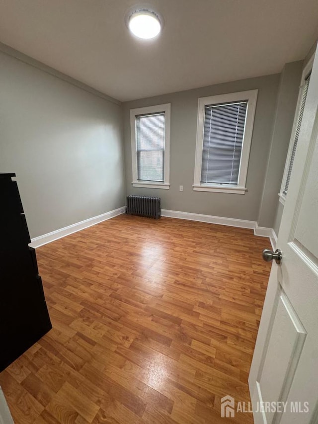 86 Harvey St, New Brunswick, NJ 08901 - empty room featuring radiator and light wood-style floors