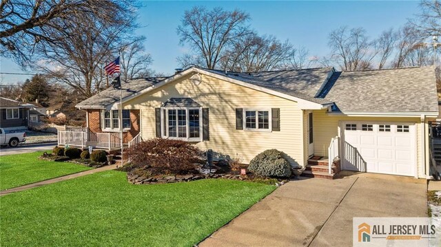 ranch-style home featuring a garage and a front yard