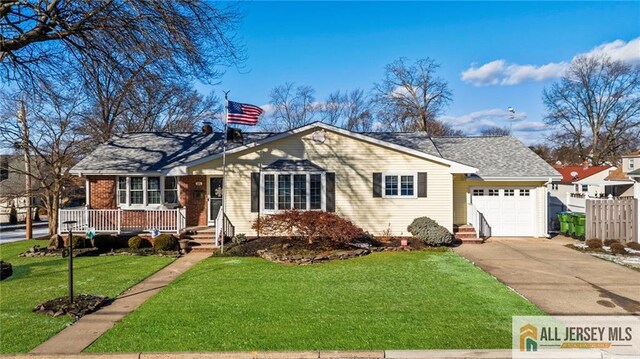 ranch-style home with a front lawn and a garage