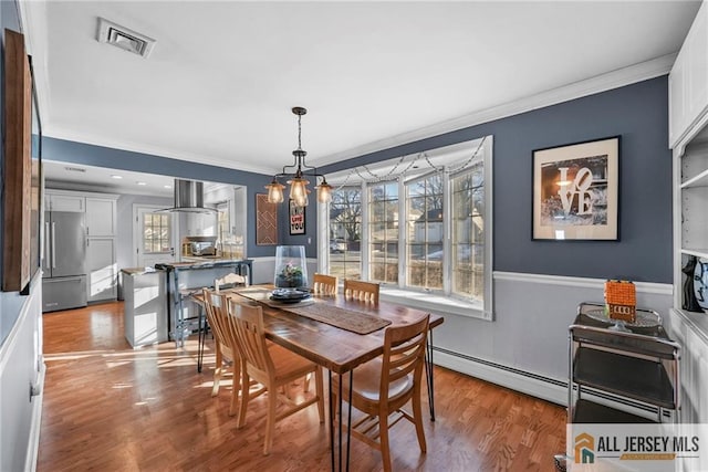 dining space featuring a baseboard radiator, plenty of natural light, wood-type flooring, and ornamental molding