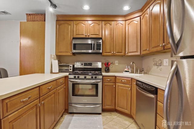 155 Pennsylvania Way N, Brunswick, NJ 08902 - kitchen featuring stainless steel appliances, a sink, light countertops, recessed lighting, and brown cabinets