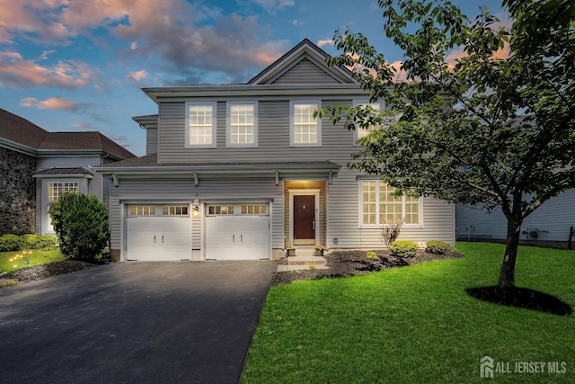 3 Lily Ln, Piscataway, NJ 08854 - traditional home featuring asphalt driveway, a front lawn, and an attached garage