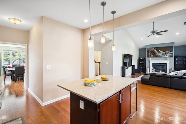 3 Lily Ln, Piscataway, NJ 08854 - kitchen featuring light wood-type flooring, a kitchen breakfast bar, a ceiling fan, decorative light fixtures, and a kitchen island