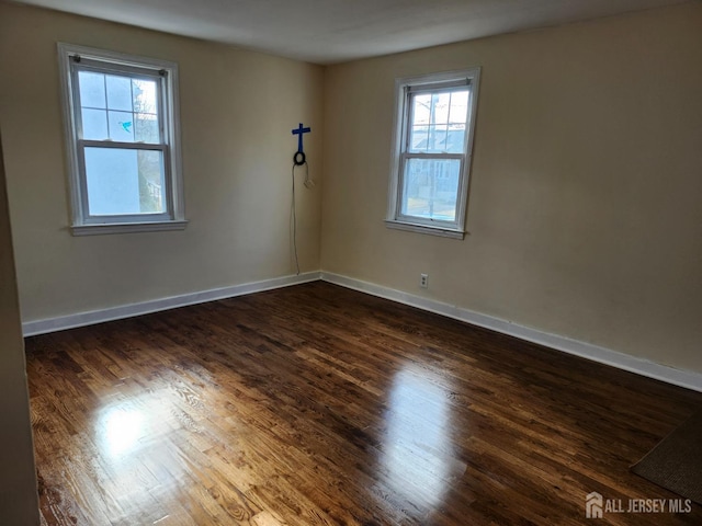 unfurnished room with dark hardwood / wood-style floors