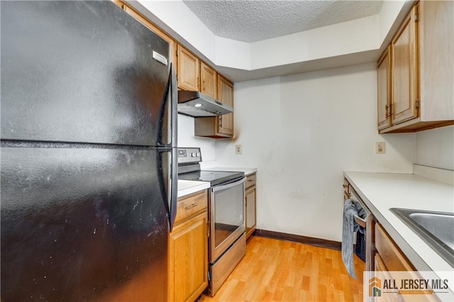 2302 Aspen Dr Unit 2302, Plainsboro, NJ 08536 - kitchen with freestanding refrigerator, stainless steel electric stove, under cabinet range hood, light wood finished floors, and light countertops