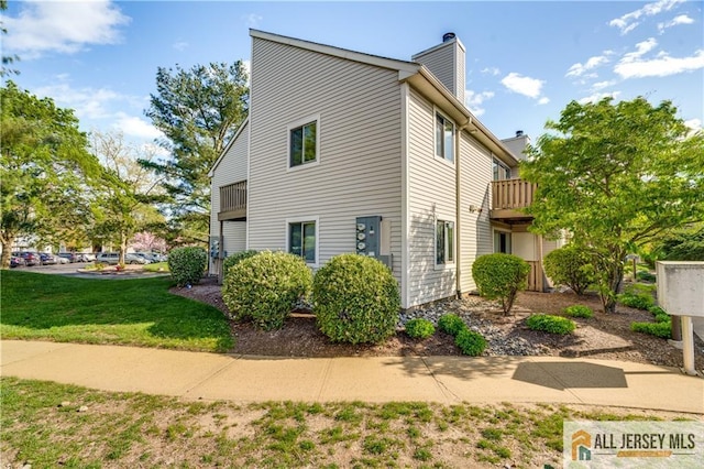 2302 Aspen Dr Unit 2302, Plainsboro, NJ 08536 - view of side of home with a chimney, a lawn, and a balcony