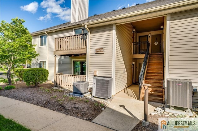 2302 Aspen Dr Unit 2302, Plainsboro, NJ 08536 - back of property with central AC unit, a balcony, and a chimney