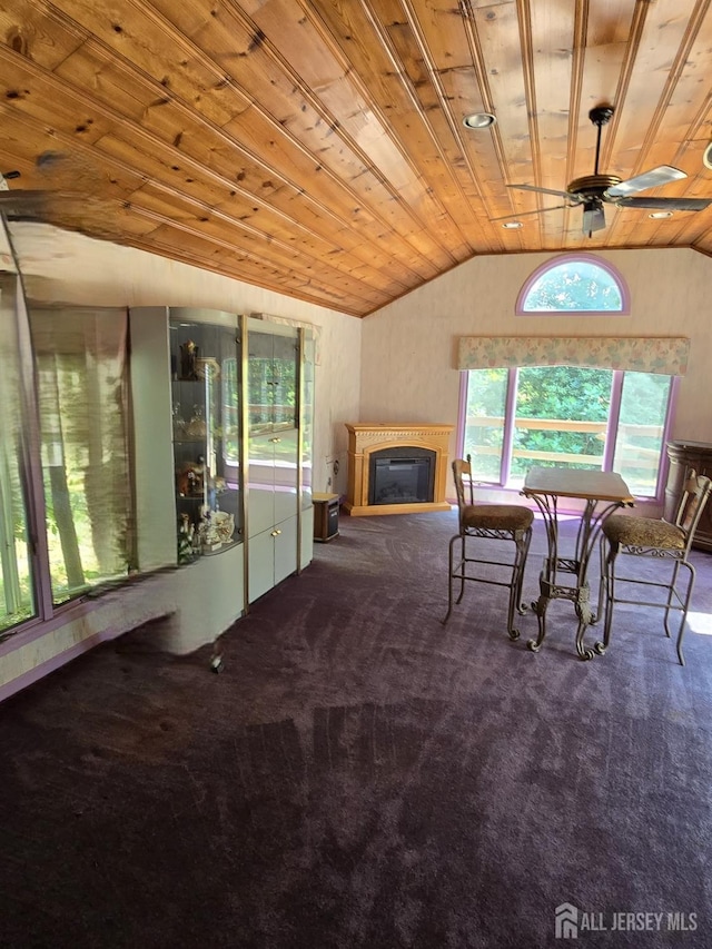 sitting room with carpet floors, lofted ceiling, ceiling fan, and wooden ceiling