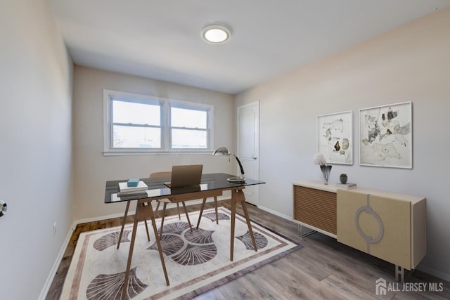 home office with baseboards and wood finished floors