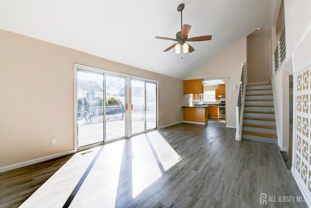 unfurnished living room with stairway, dark wood-style floors, visible vents, and baseboards