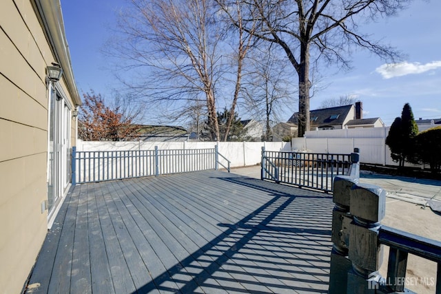 wooden deck featuring a fenced backyard