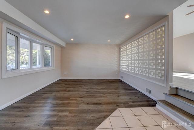 empty room featuring recessed lighting, visible vents, baseboards, and wood finished floors