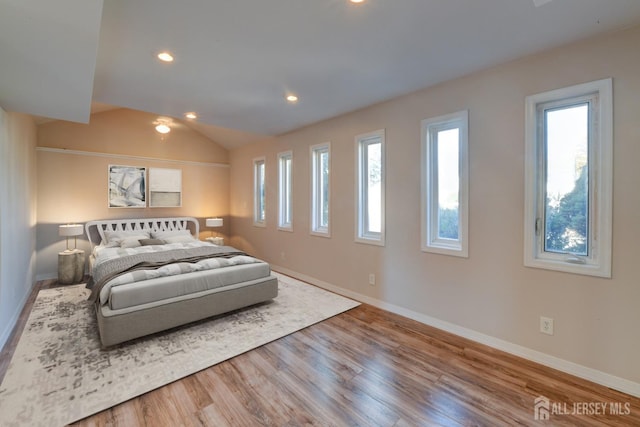 bedroom featuring recessed lighting, baseboards, wood finished floors, and vaulted ceiling