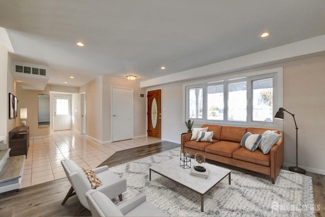 living room with light tile patterned flooring, recessed lighting, and visible vents