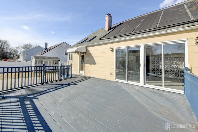 deck featuring an outbuilding and fence