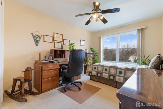 office area featuring light colored carpet and ceiling fan