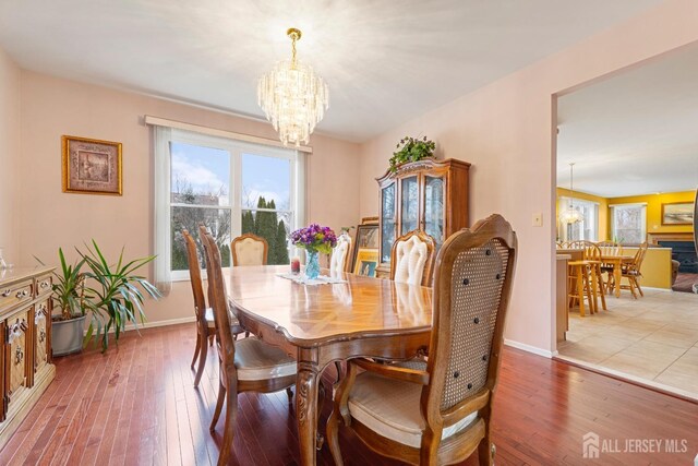 dining room with hardwood / wood-style floors and a notable chandelier