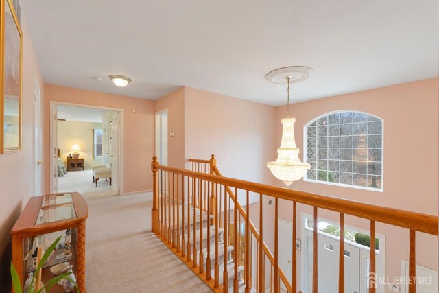 hallway featuring light colored carpet