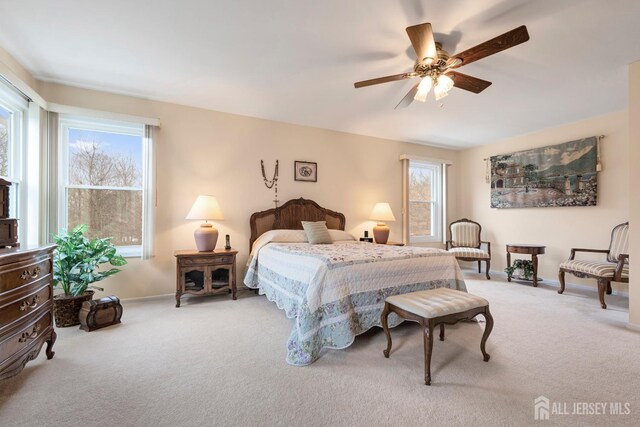 bedroom with ceiling fan and light colored carpet