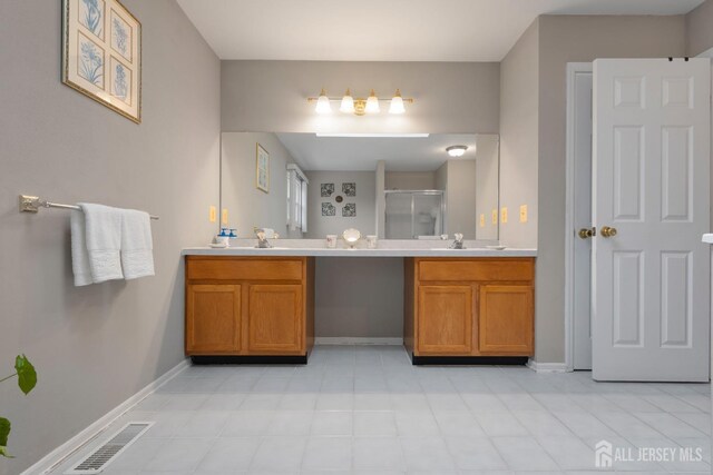 bathroom featuring vanity and a shower with shower door