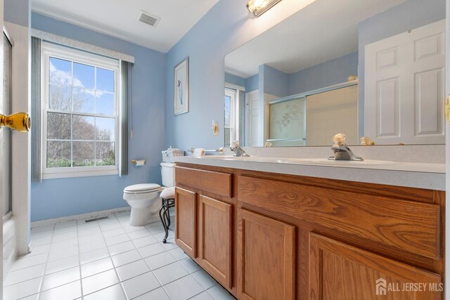 bathroom with tile patterned floors, vanity, and toilet