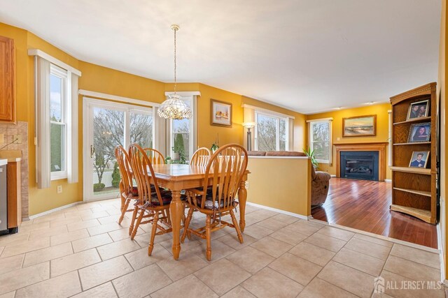 dining area with light tile patterned floors and a chandelier