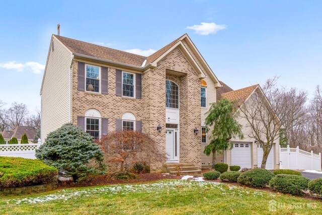 view of front of house with a front yard and a garage