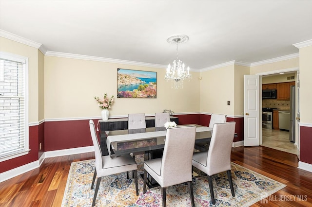 dining room featuring a chandelier, plenty of natural light, and hardwood / wood-style flooring