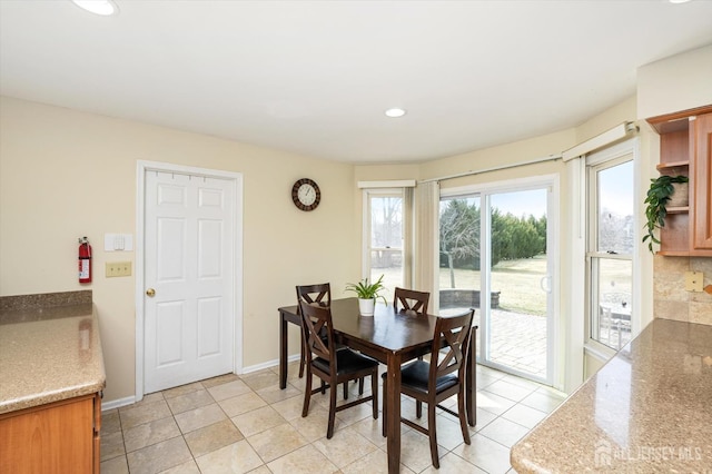 dining area with light tile patterned floors, recessed lighting, and baseboards