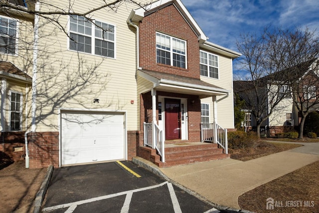 view of front of house with a garage and brick siding