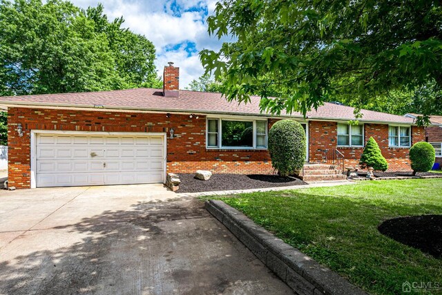 ranch-style home with a garage and a front yard