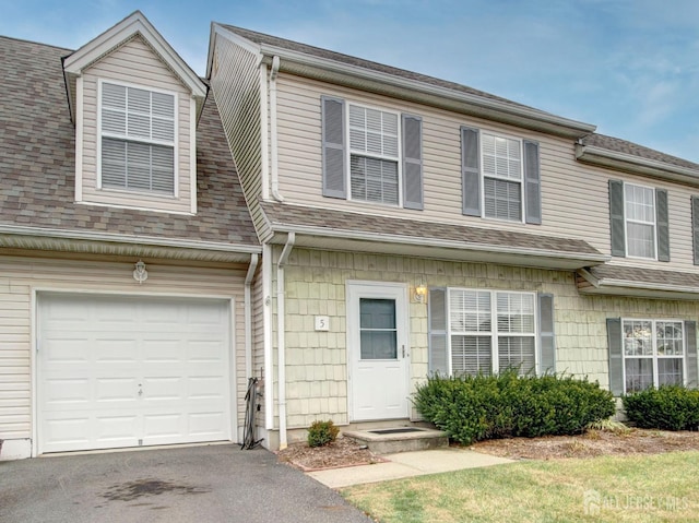 townhome / multi-family property featuring a garage