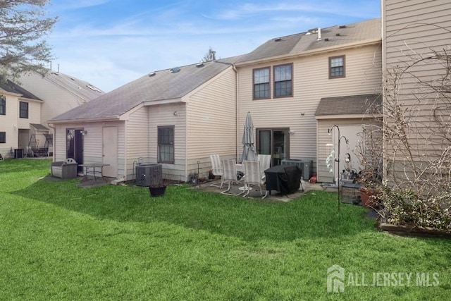 back of property featuring cooling unit and a lawn