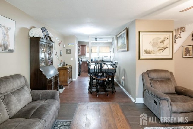 living area featuring dark wood-style floors and baseboards