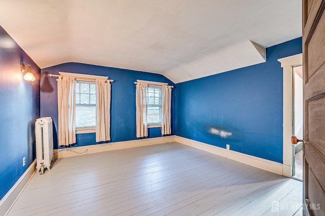 404 Mountainview Ter, Dunellen, NJ 08812 - unfurnished room with radiator, vaulted ceiling, wood-type flooring, and baseboards