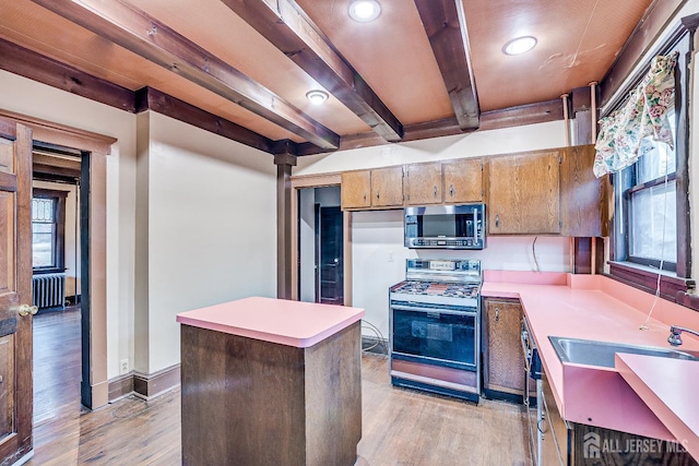 404 Mountainview Ter, Dunellen, NJ 08812 - kitchen with appliances with stainless steel finishes, radiator heating unit, light wood-style flooring, light countertops, and beam ceiling
