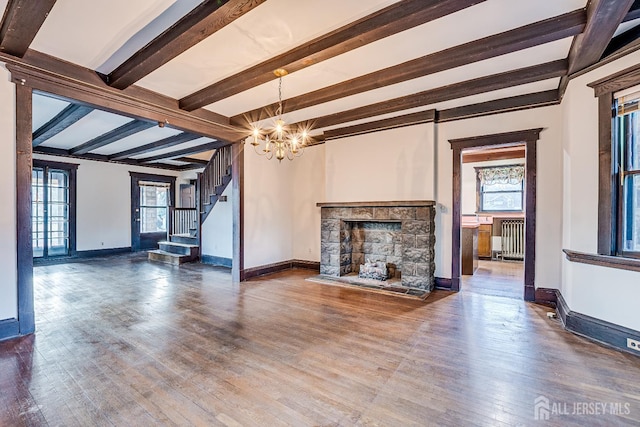 404 Mountainview Ter, Dunellen, NJ 08812 - unfurnished living room with radiator heating unit, a chandelier, beam ceiling, a stone fireplace, and baseboards