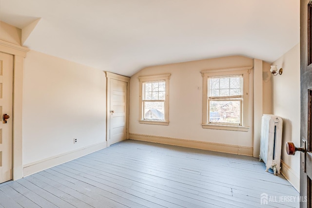 404 Mountainview Ter, Dunellen, NJ 08812 - spare room with radiator heating unit, lofted ceiling, light wood finished floors, and baseboards