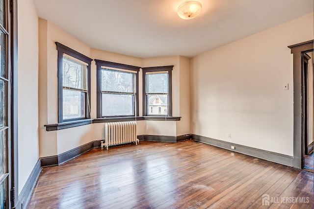 404 Mountainview Ter, Dunellen, NJ 08812 - unfurnished room with radiator heating unit, hardwood / wood-style flooring, and baseboards
