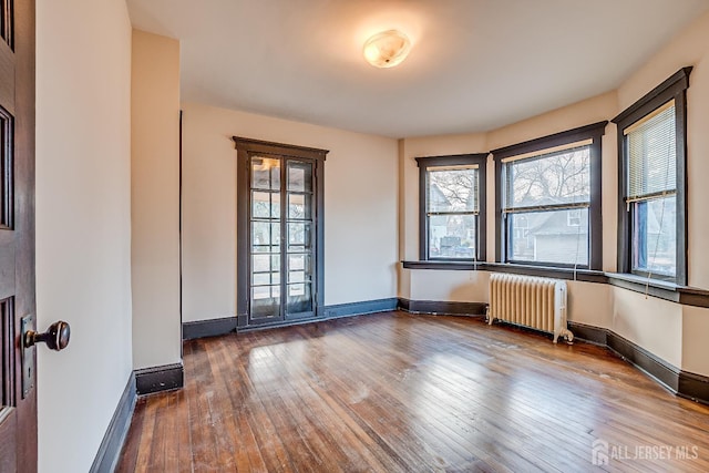 404 Mountainview Ter, Dunellen, NJ 08812 - unfurnished room featuring radiator, hardwood / wood-style flooring, and baseboards