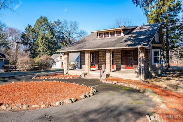 404 Mountainview Ter, Dunellen, NJ 08812 - view of front of house featuring covered porch, a chimney, and stone siding