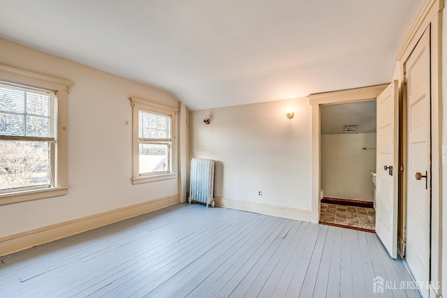 404 Mountainview Ter, Dunellen, NJ 08812 - unfurnished bedroom featuring radiator, hardwood / wood-style flooring, vaulted ceiling, baseboards, and multiple windows