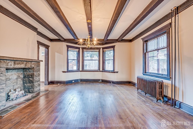 unfurnished living room featuring radiator heating unit, wood-type flooring, beam ceiling, and baseboards