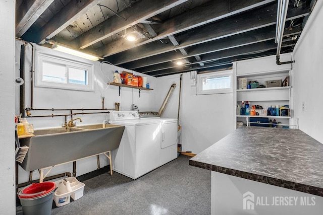 laundry area featuring washer and clothes dryer, laundry area, and a sink