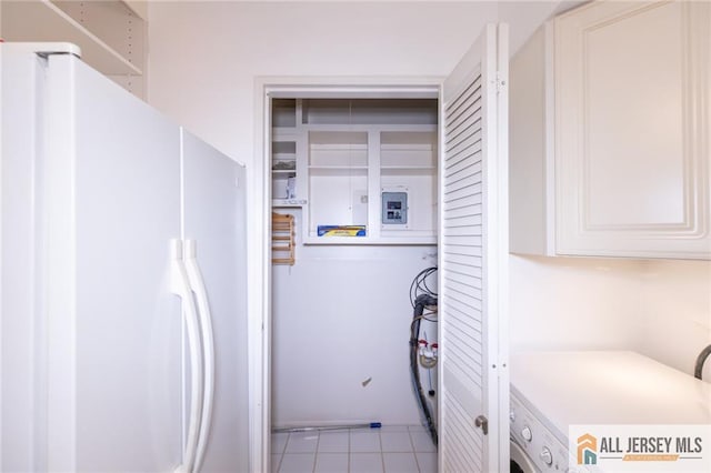 50 Prospect St Unit 09, Metuchen, NJ 08840 - laundry area featuring cabinet space, light tile patterned flooring, and washer / clothes dryer