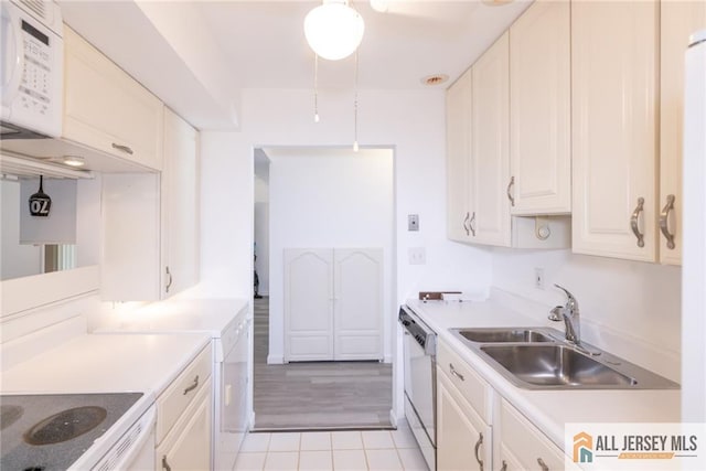 50 Prospect St Unit 09, Metuchen, NJ 08840 - kitchen with white appliances, light countertops, white cabinetry, and light tile patterned flooring