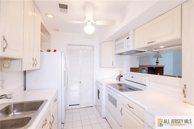 50 Prospect St Unit 09, Metuchen, NJ 08840 - kitchen with white appliances, independent washer and dryer, light tile patterned floors, light countertops, and white cabinets