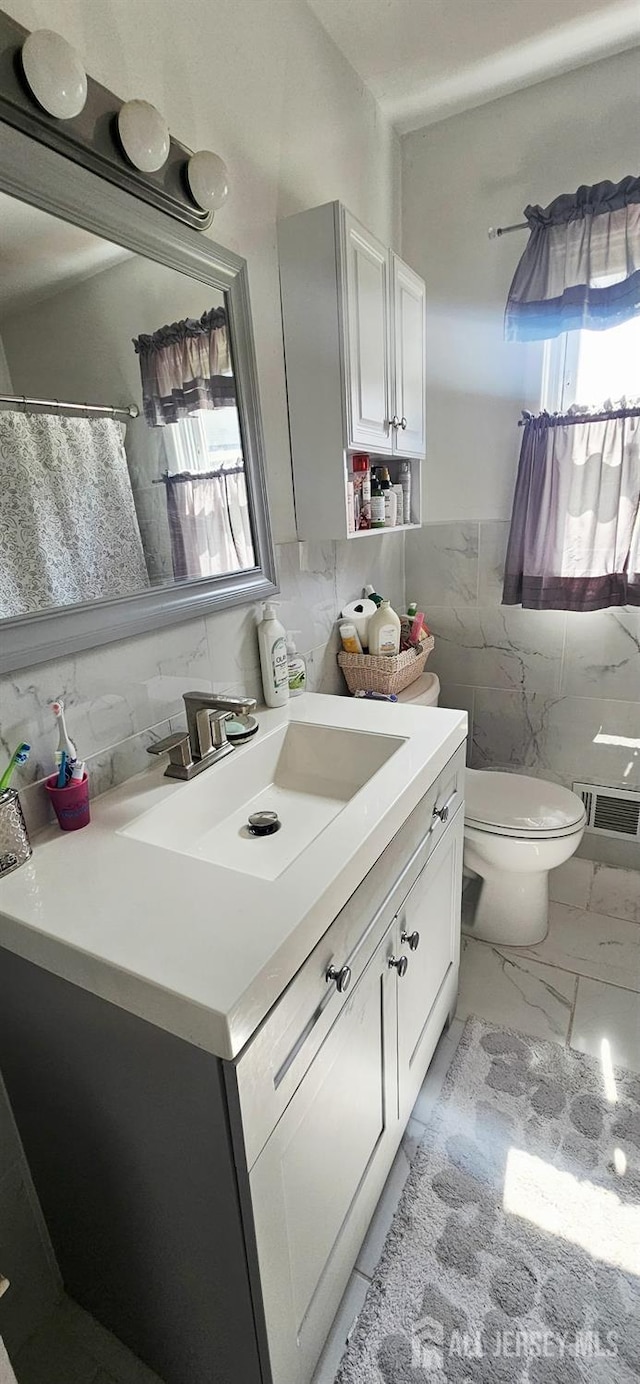 789 Barry Ave, Perth Amboy, NJ 08861 - bathroom with vanity, tile walls, marble look tiles, and curtained shower
