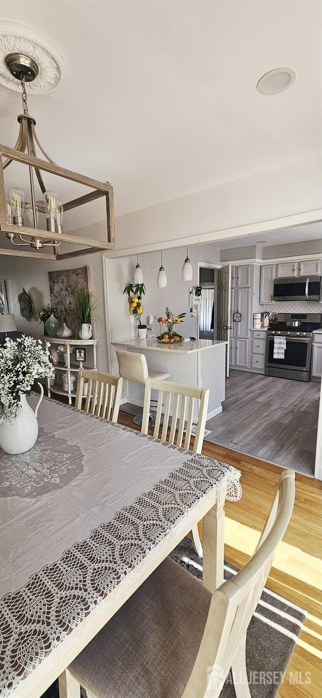 789 Barry Ave, Perth Amboy, NJ 08861 - dining room featuring a chandelier and wood finished floors