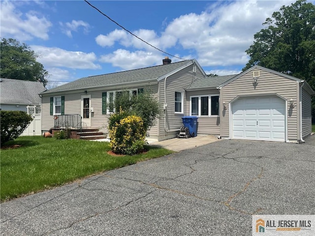69 Tappen St, Avenel, NJ 07001 - ranch-style home featuring an attached garage, a front yard, asphalt driveway, roof with shingles, and a chimney